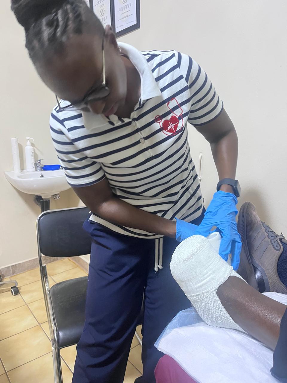 Path-Clinic practitioner applying a leg wound dressing